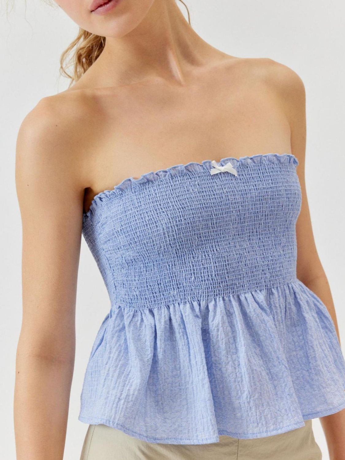 "Woman wearing ruffled tube top with layered detail, perfect for summer outfits and casual chic style"