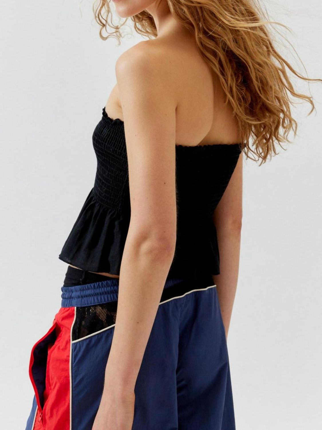 "Woman wearing ruffled tube top with layered detail, perfect for summer outfits and casual chic style"