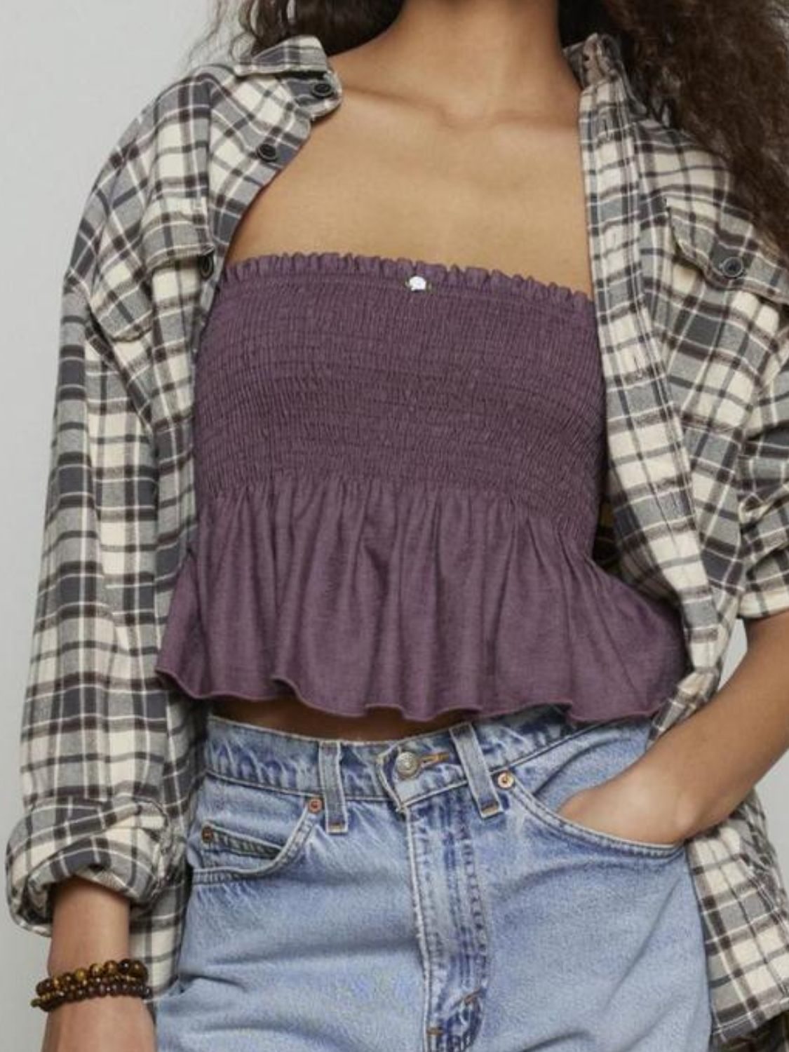 "Woman wearing ruffled tube top with layered detail, perfect for summer outfits and casual chic style"
