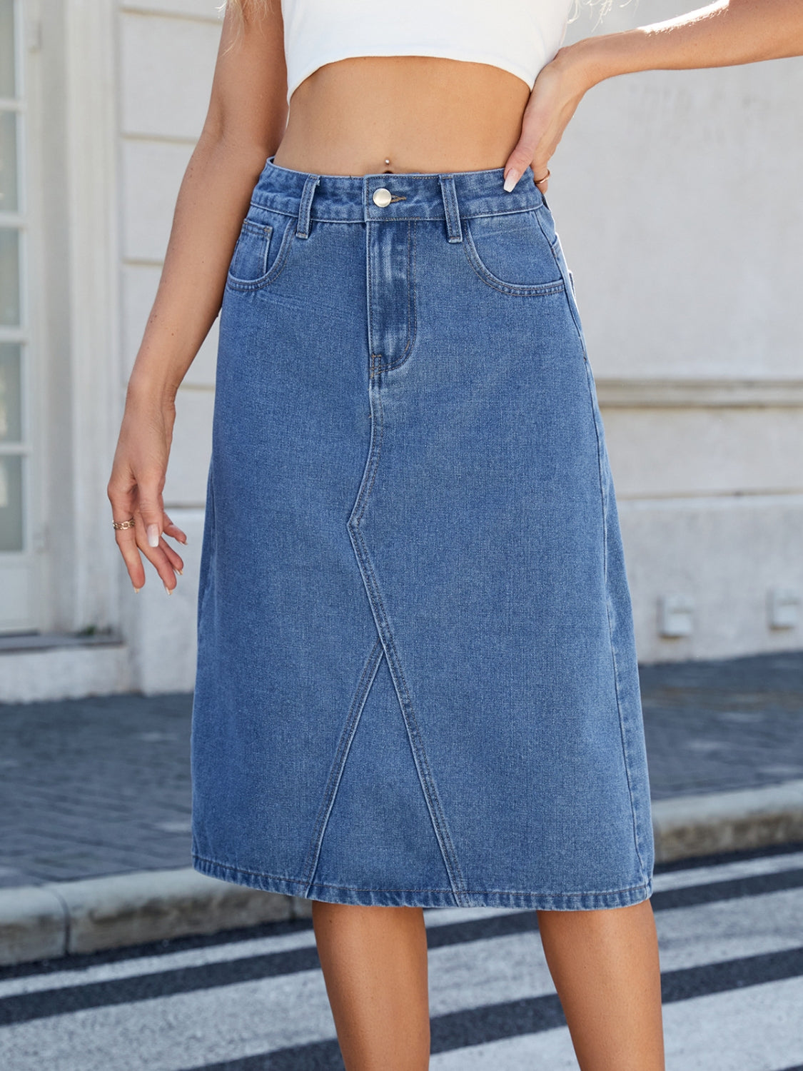 "Women's slit back denim skirt, trendy and chic, with a sleek fit and raw hem detail, perfect for casual wear or dressed-up outfits, versatile and stylish"