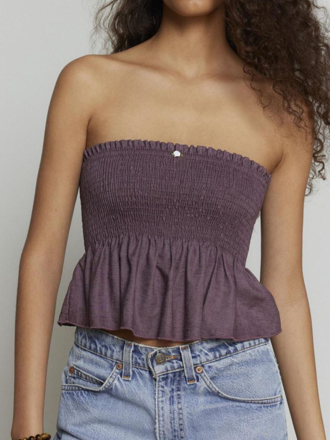 "Woman wearing ruffled tube top with layered detail, perfect for summer outfits and casual chic style"