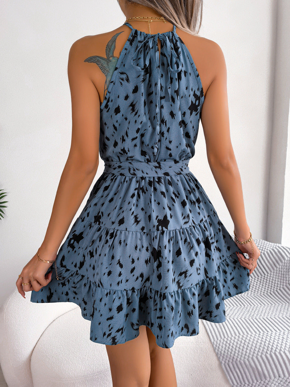 "Chic printed halter neck sleeveless mini dress with A-line hem, perfect for casual outings or beach days with a flattering fit and bold pattern."