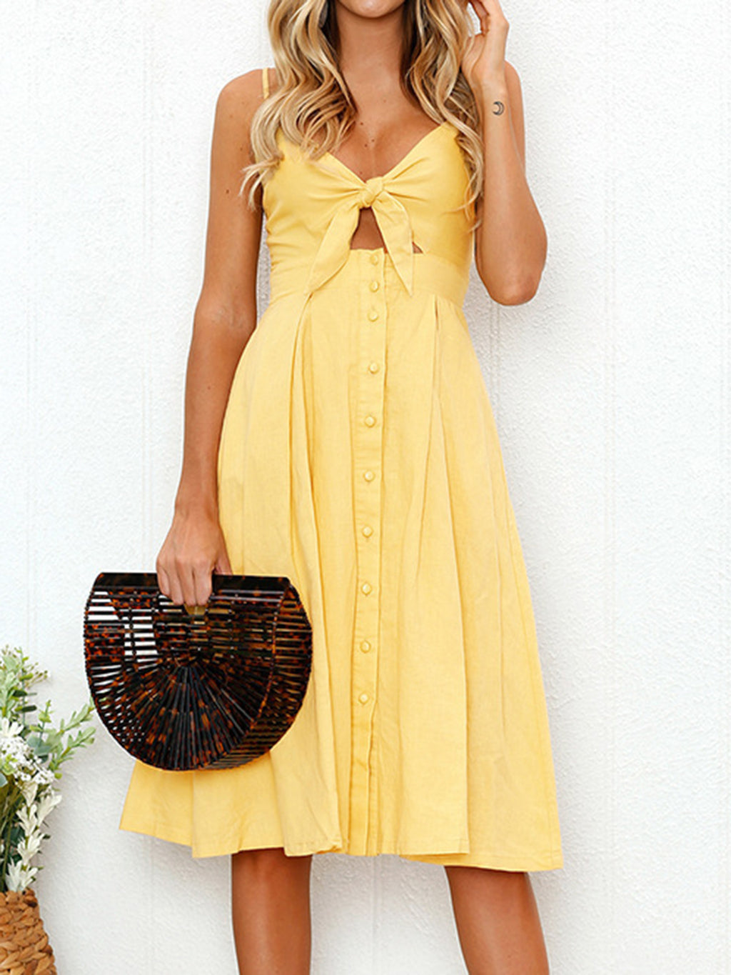 "Chic cutout sweetheart neckline cami dress with decorative button details. Flirty and feminine style, perfect for casual or evening outings."