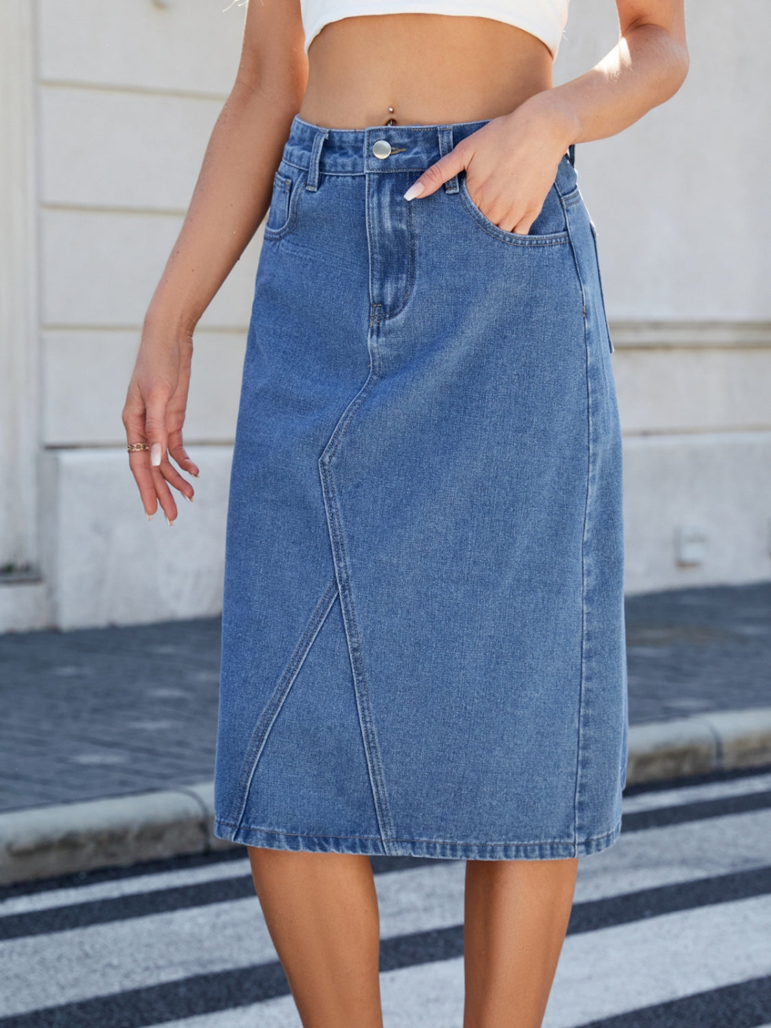 "Women's slit back denim skirt, trendy and chic, with a sleek fit and raw hem detail, perfect for casual wear or dressed-up outfits, versatile and stylish"