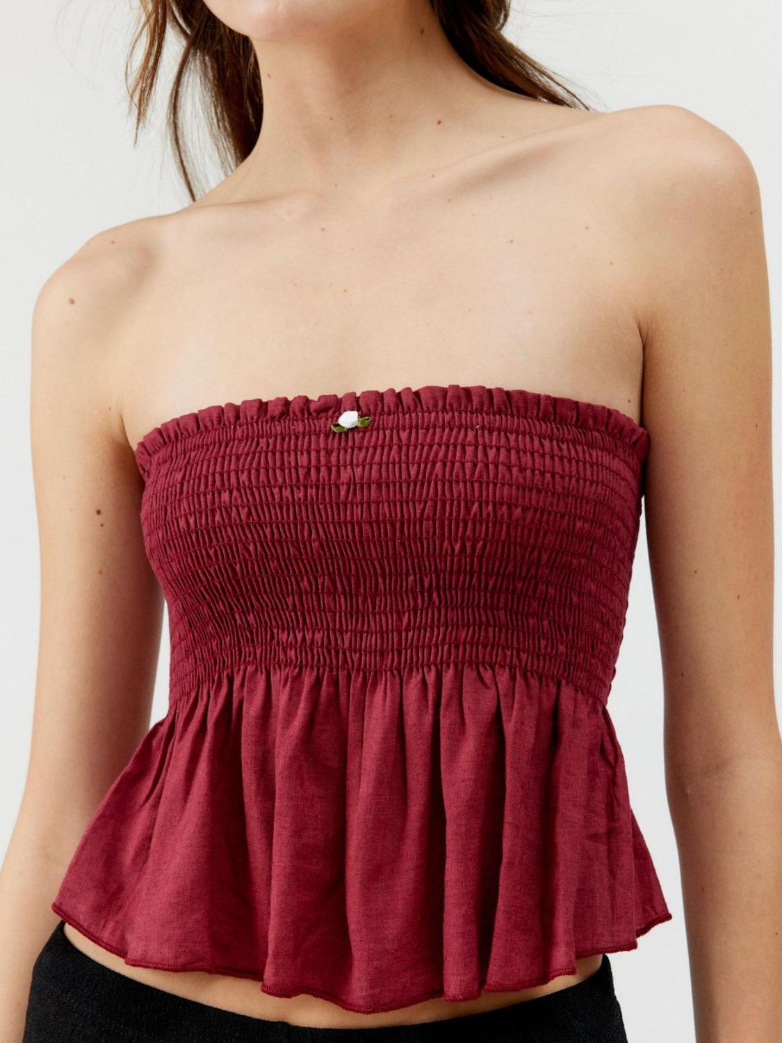 "Woman wearing ruffled tube top with layered detail, perfect for summer outfits and casual chic style"