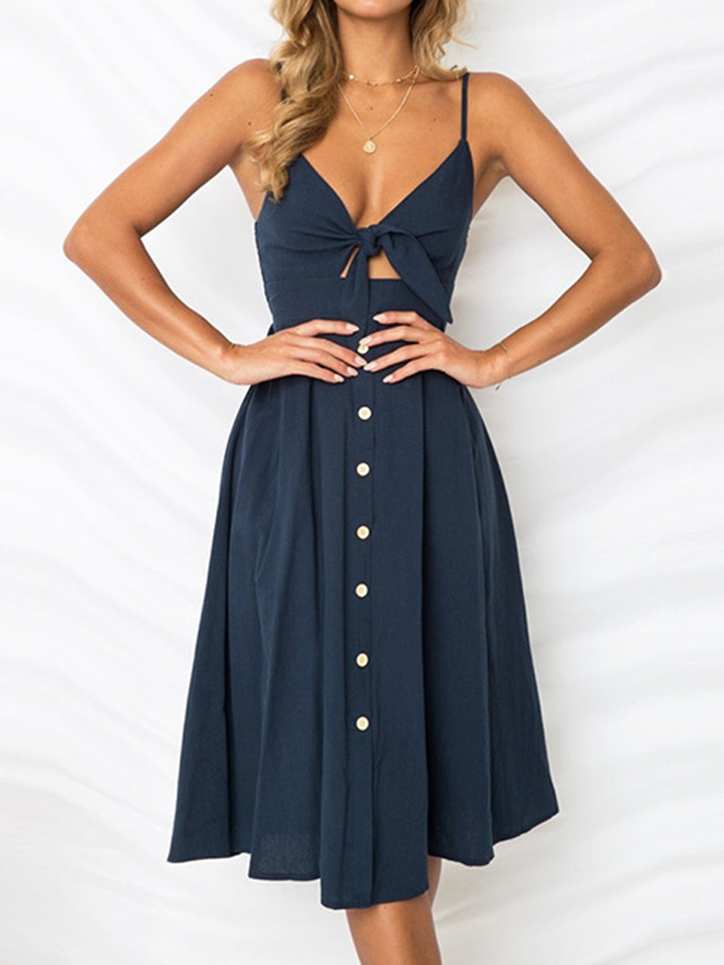 "Chic cutout sweetheart neckline cami dress with decorative button details. Flirty and feminine style, perfect for casual or evening outings."