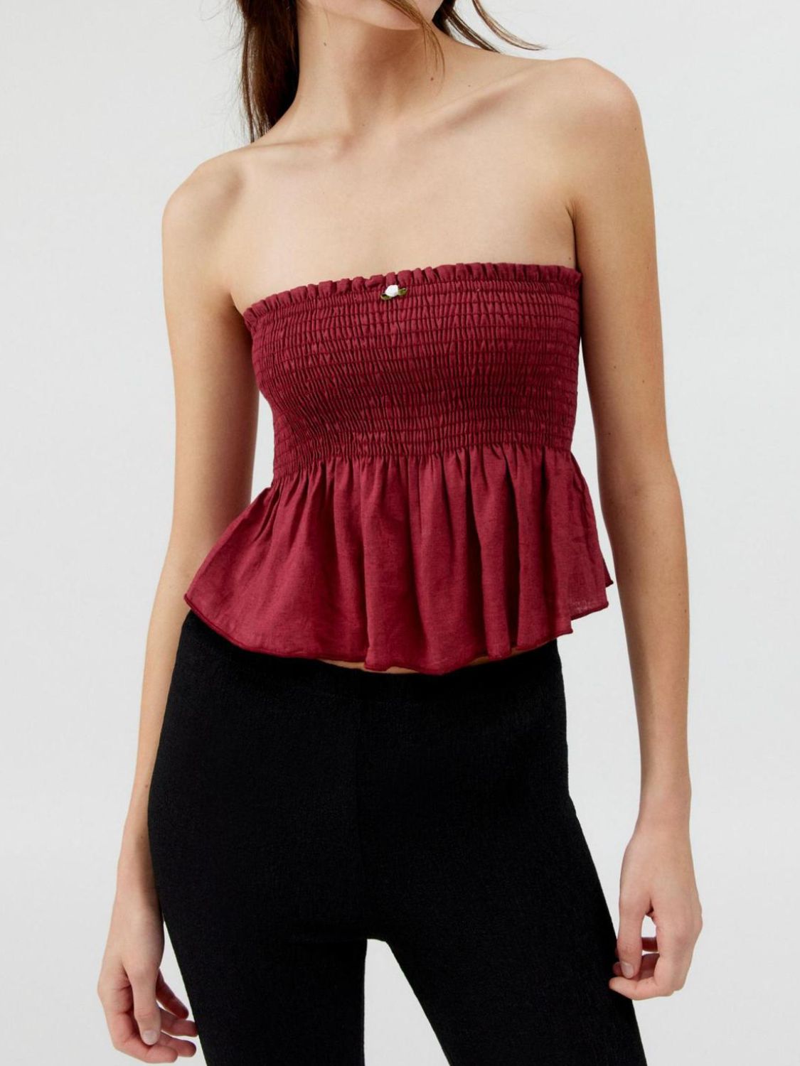 "Woman wearing ruffled tube top with layered detail, perfect for summer outfits and casual chic style"