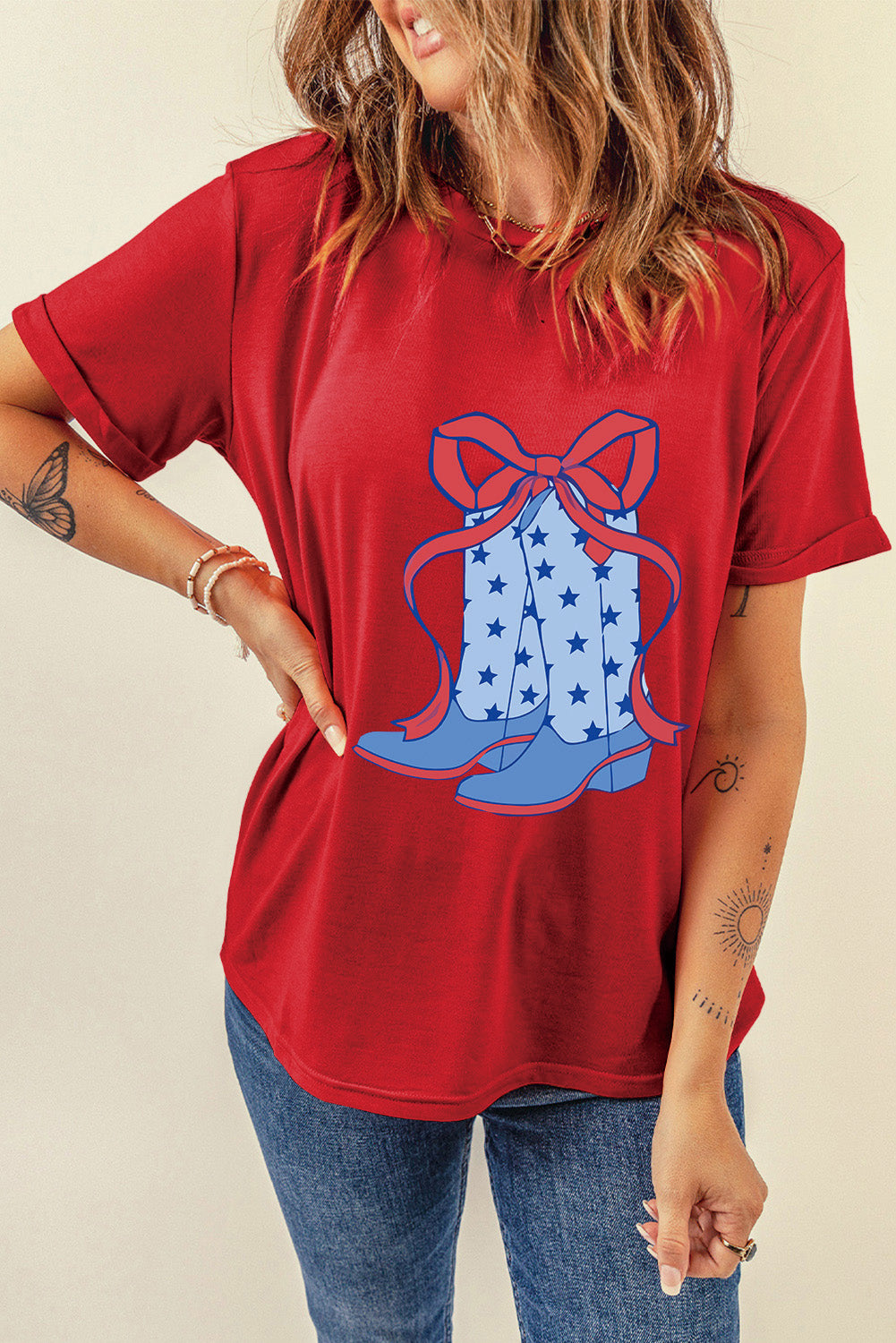 "Boots & Bow Tee – Western-inspired graphic t-shirt with a mix of cowboy charm and feminine flair, perfect for country lovers."