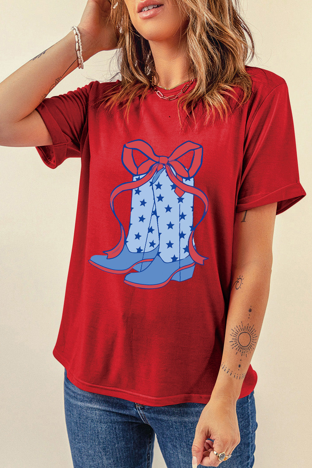 "Boots & Bow Tee – Western-inspired graphic t-shirt with a mix of cowboy charm and feminine flair, perfect for country lovers."