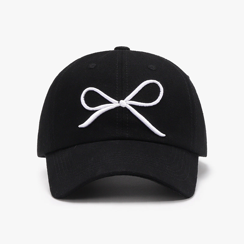 "Bow Baseball Cap – Stylish and adjustable cap featuring a chic bow detail, perfect for a sporty yet feminine look."
