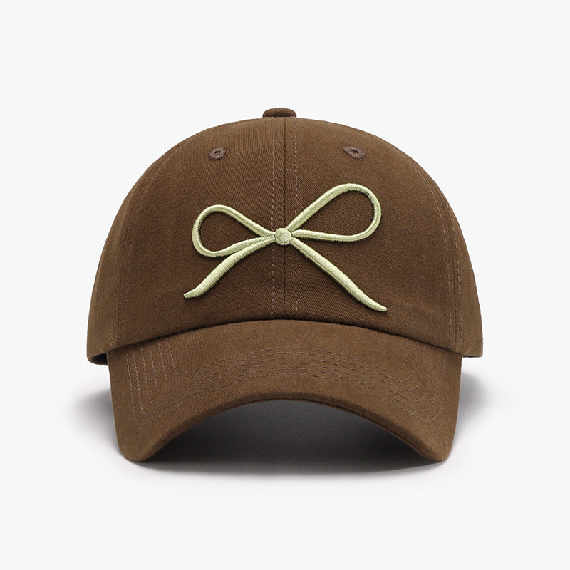 "Bow Baseball Cap – Stylish and adjustable cap featuring a chic bow detail, perfect for a sporty yet feminine look."