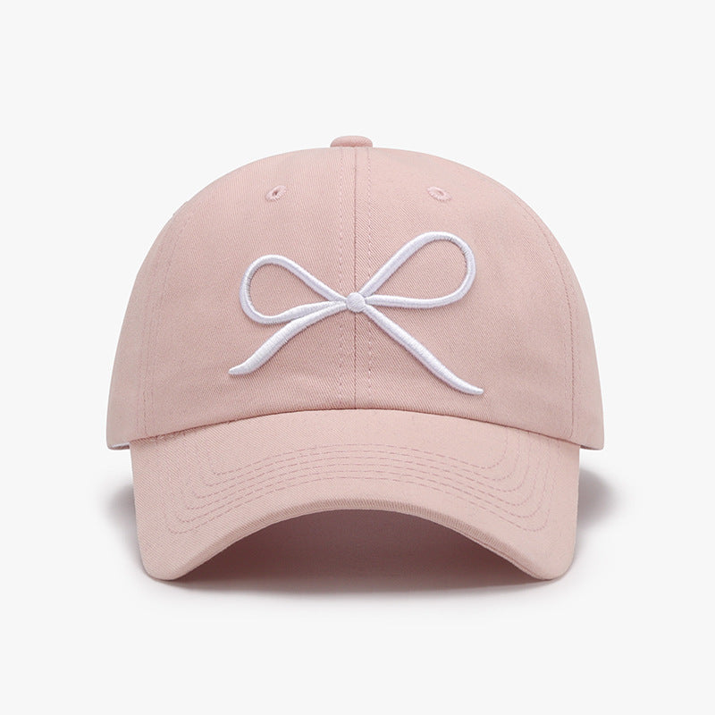 "Bow Baseball Cap – Stylish and adjustable cap featuring a chic bow detail, perfect for a sporty yet feminine look."