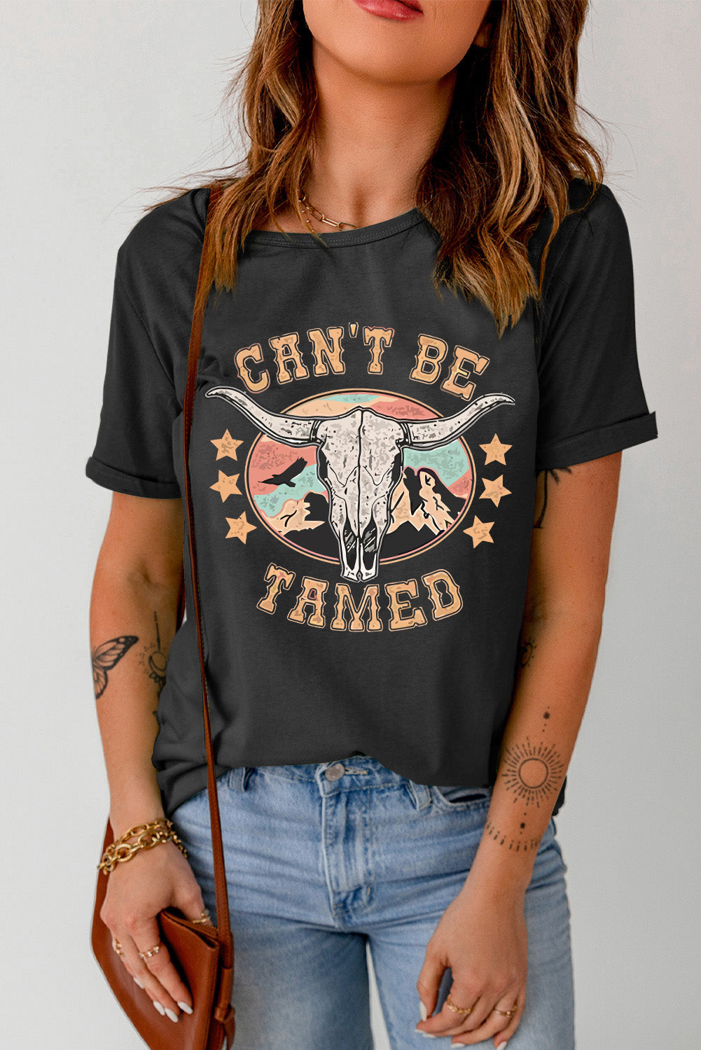 Can’t Be Tamed Tee – Bold and fearless graphic t-shirt with a relaxed fit, perfect for making a statement."
