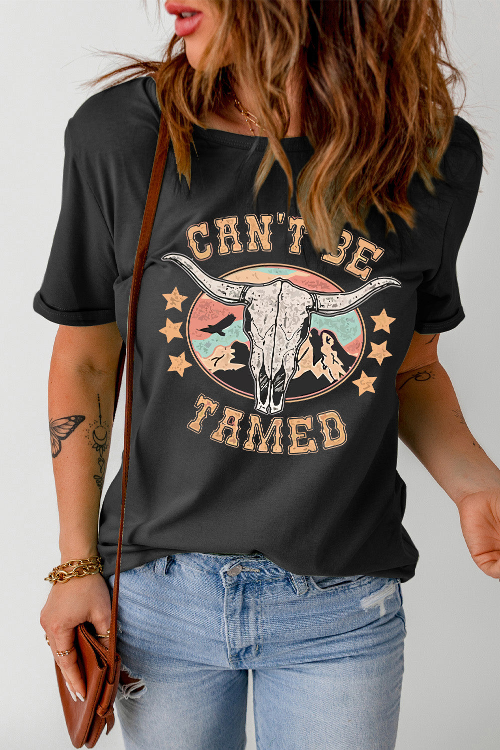 Can’t Be Tamed Tee – Bold and fearless graphic t-shirt with a relaxed fit, perfect for making a statement."
