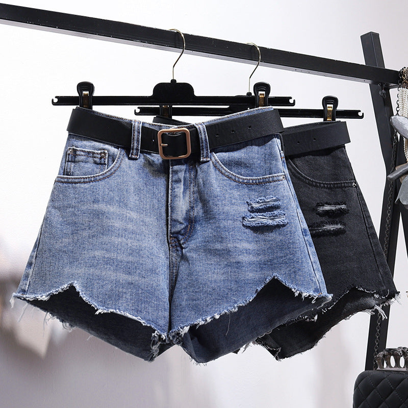 "Irregular denim shorts with asymmetrical cut and raw-edge details, stylish cotton denim shorts for a trendy streetwear look."