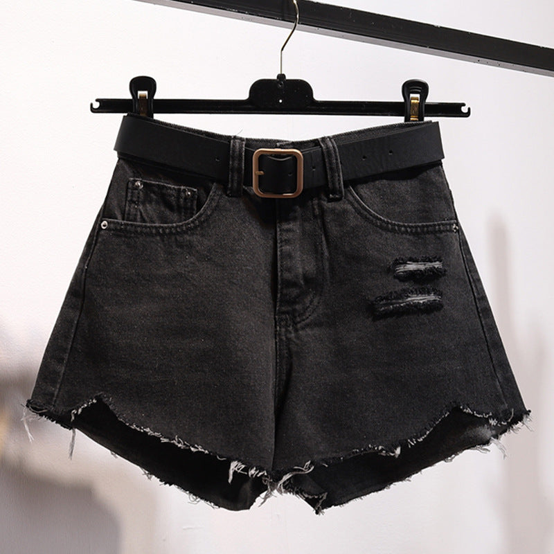 "Irregular denim shorts with asymmetrical cut and raw-edge details, stylish cotton denim shorts for a trendy streetwear look."