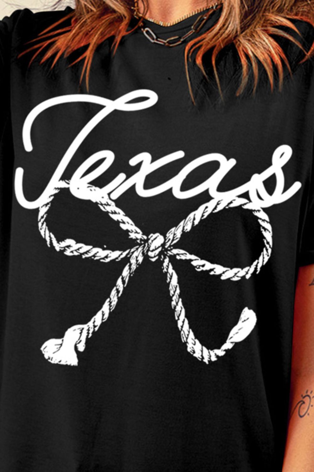 "Texas Bow Tee with a playful bow design, featuring a bold graphic print perfect for showing off your Texas pride in a stylish and casual way."