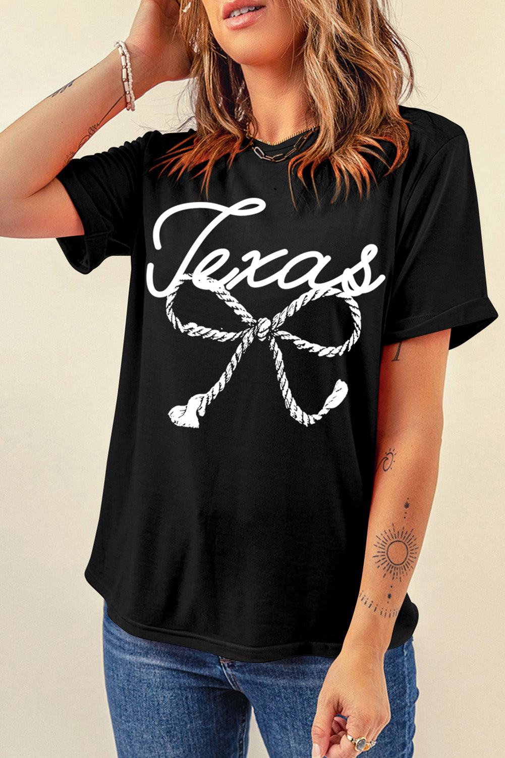 "Texas Bow Tee with a playful bow design, featuring a bold graphic print perfect for showing off your Texas pride in a stylish and casual way."