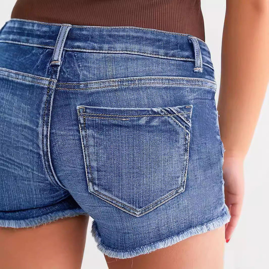 "Trendy ripped denim shorts – stylish street fashion, light blue distressed jean shorts for a chic casual look."