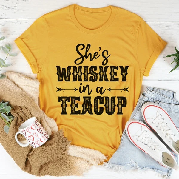 "Whiskey in a Teacup Graphic Tee featuring vintage-inspired typography on soft, breathable cotton for a bold and stylish look."