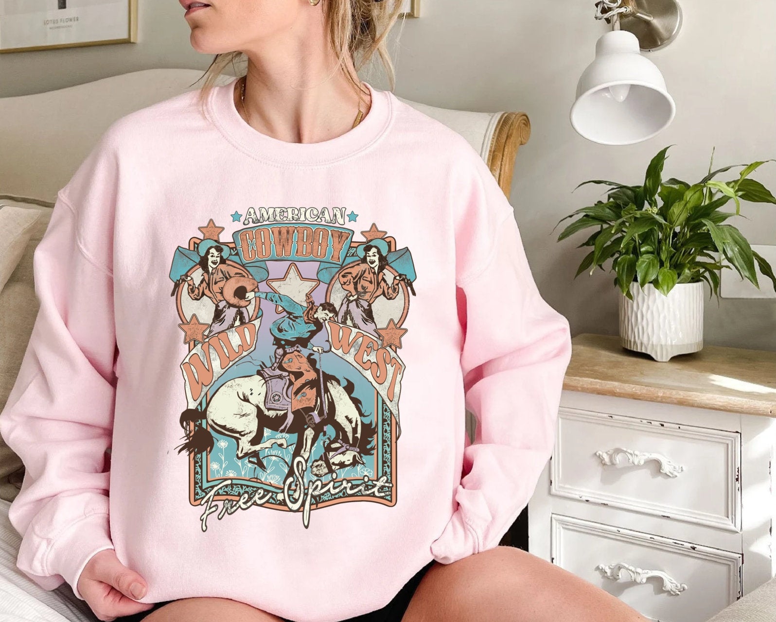 "Wild West Free Spirit graphic t-shirt in polyester fabric, available in white, gray, red, and pink colors."