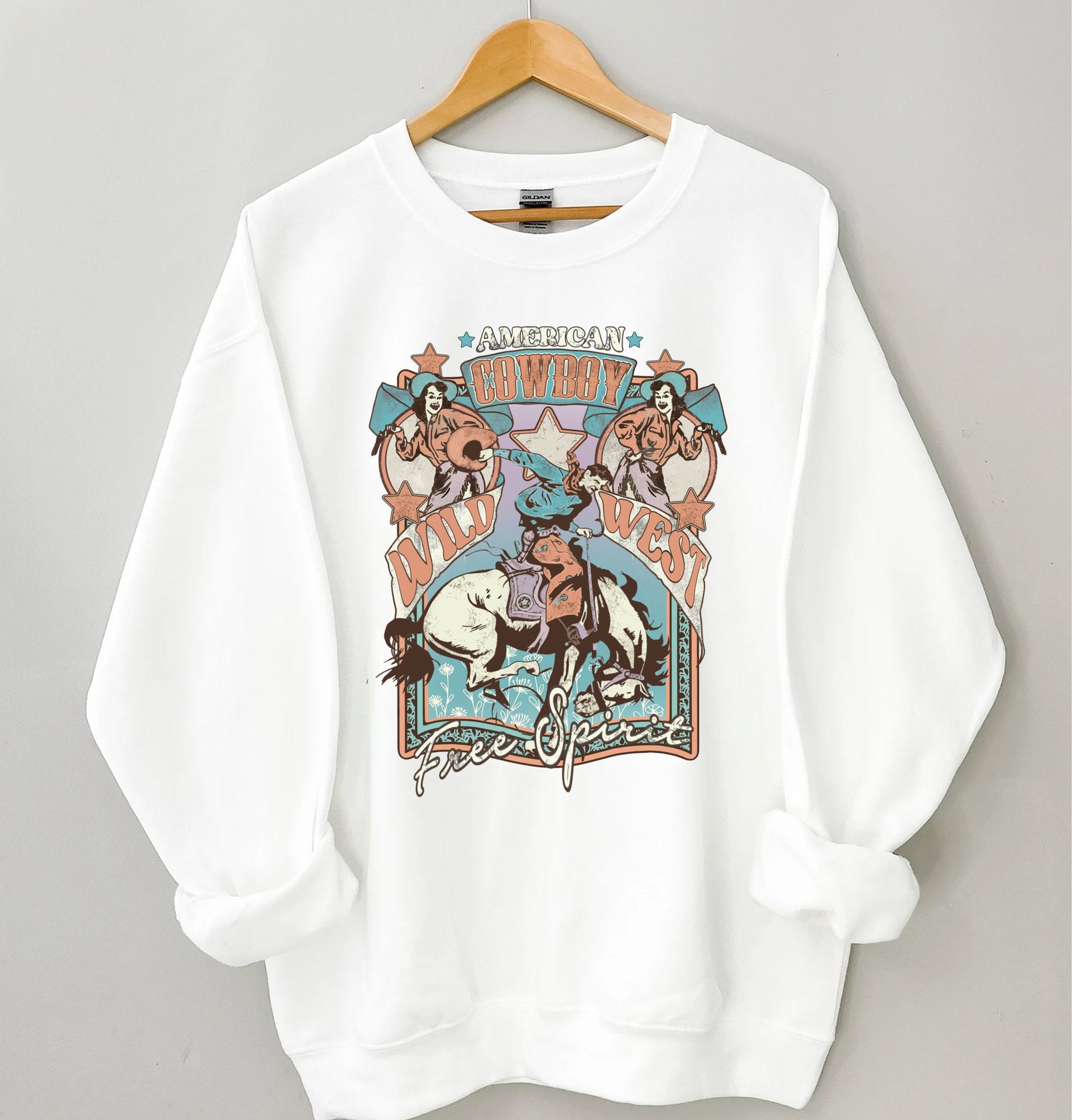 "Wild West Free Spirit graphic t-shirt in polyester fabric, available in white, gray, red, and pink colors."