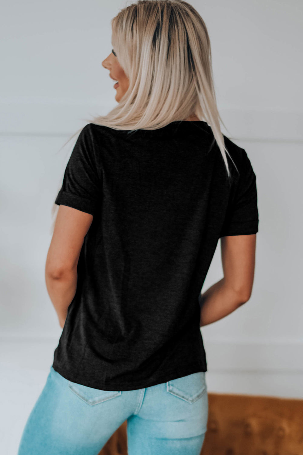 "Woman wearing Bow & Boot graphic tee with western boots and casual denim for a trendy country look"