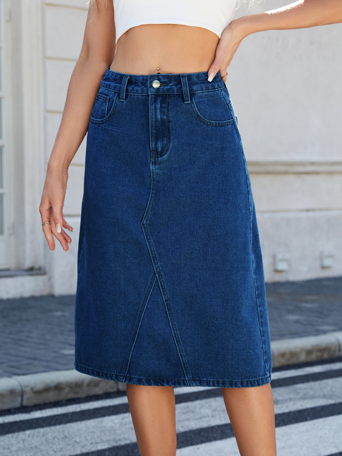 "Women's slit back denim skirt, trendy and chic, with a sleek fit and raw hem detail, perfect for casual wear or dressed-up outfits, versatile and stylish"