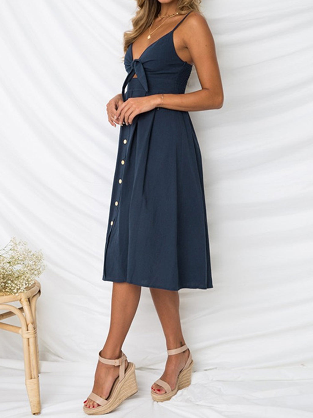 "Chic cutout sweetheart neckline cami dress with decorative button details. Flirty and feminine style, perfect for casual or evening outings."