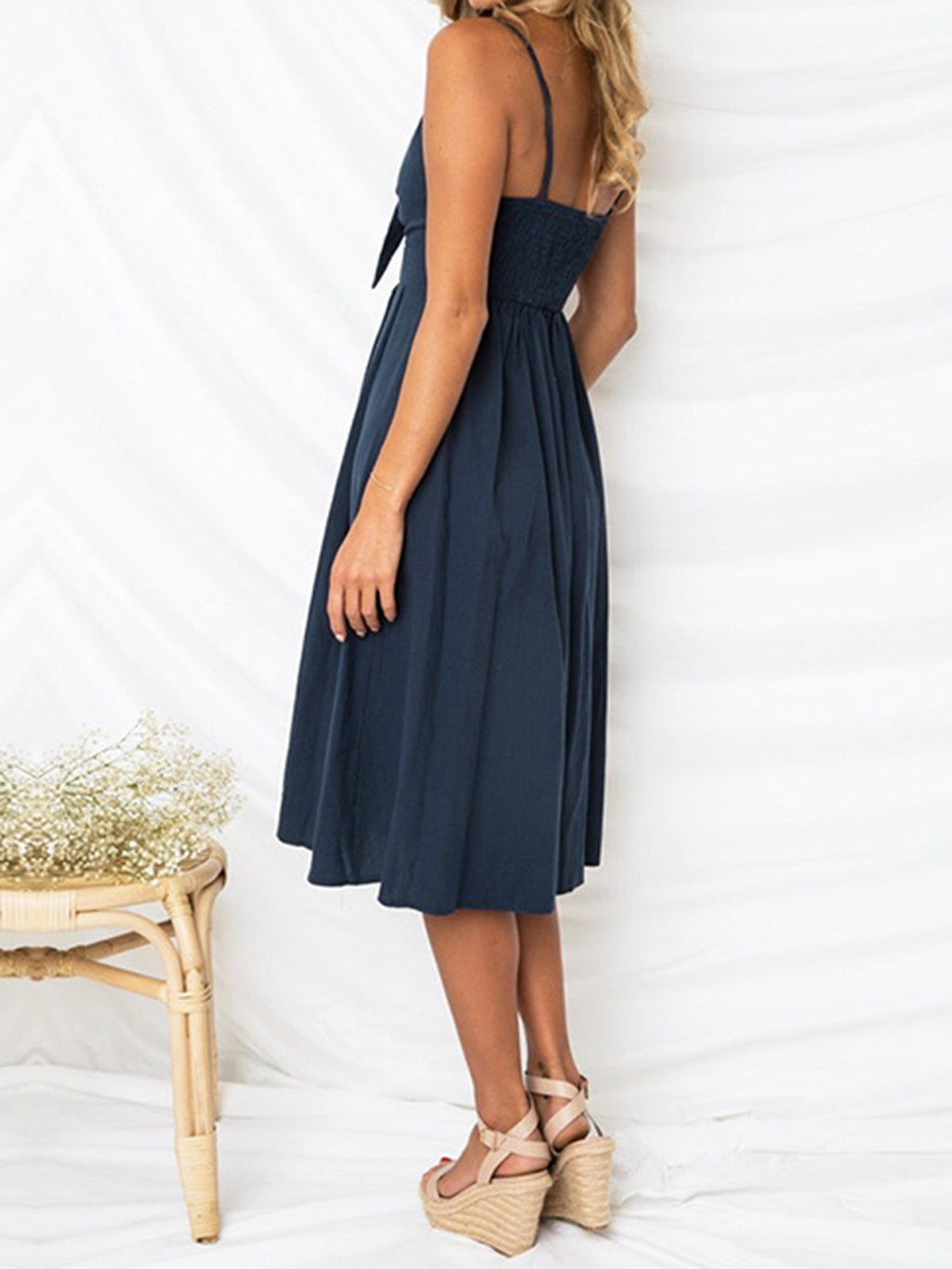 "Chic cutout sweetheart neckline cami dress with decorative button details. Flirty and feminine style, perfect for casual or evening outings."