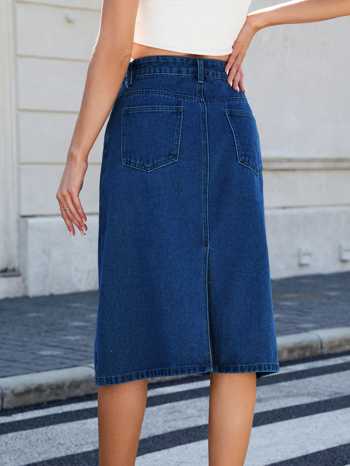 "Women's slit back denim skirt, trendy and chic, with a sleek fit and raw hem detail, perfect for casual wear or dressed-up outfits, versatile and stylish"