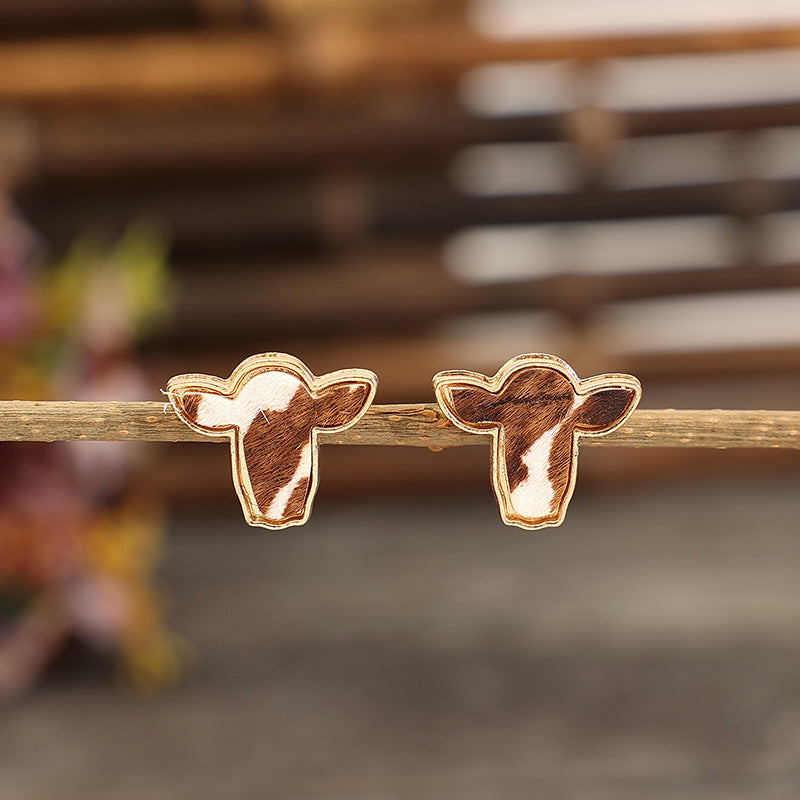 "Trendy cattle head earrings with rustic Western charm, perfect for adding a bold and stylish statement to any outfit."