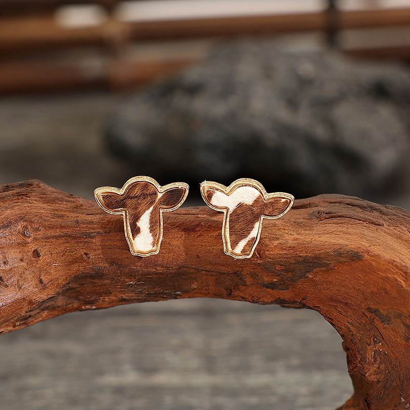 "Trendy cattle head earrings with rustic Western charm, perfect for adding a bold and stylish statement to any outfit."