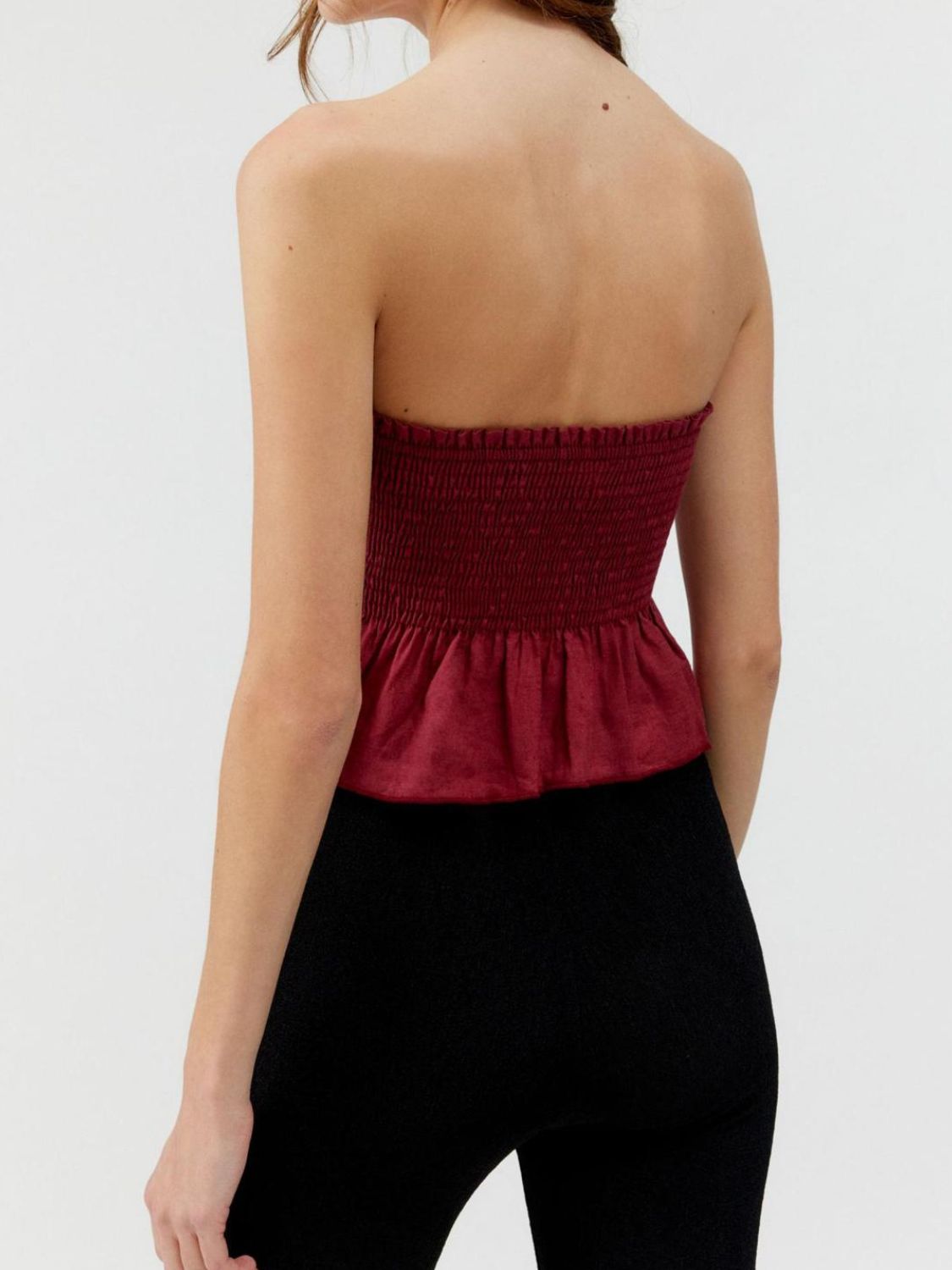 "Woman wearing ruffled tube top with layered detail, perfect for summer outfits and casual chic style"