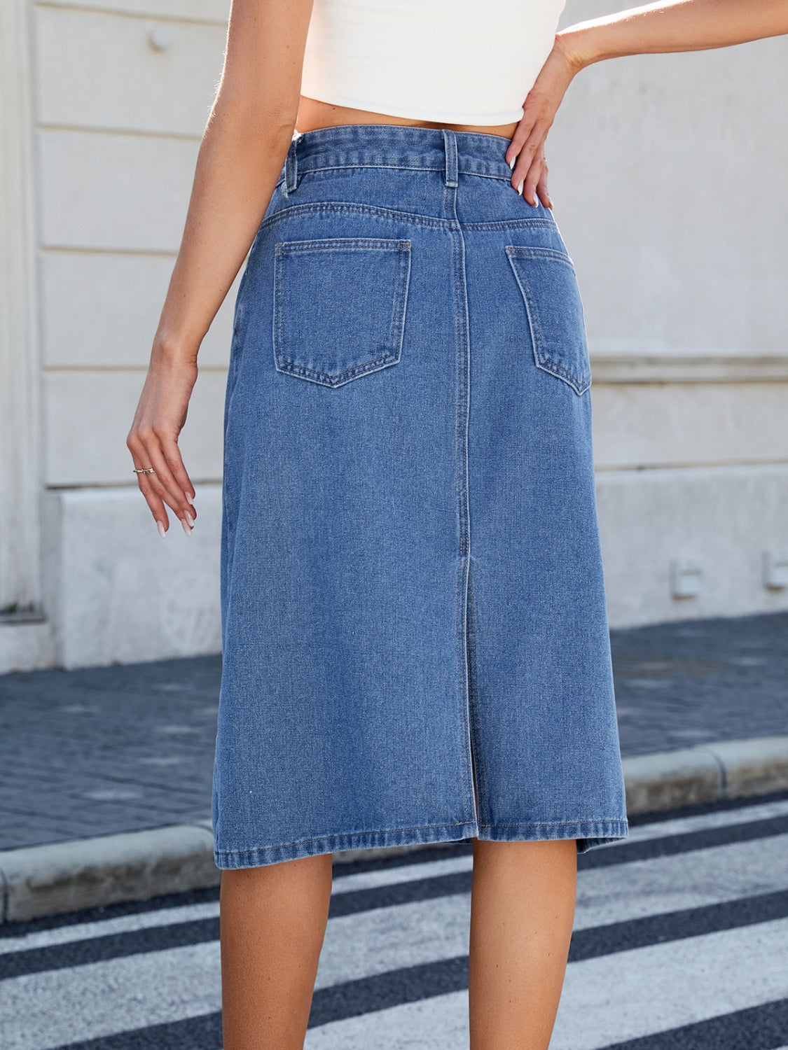 "Women's slit back denim skirt, trendy and chic, with a sleek fit and raw hem detail, perfect for casual wear or dressed-up outfits, versatile and stylish"