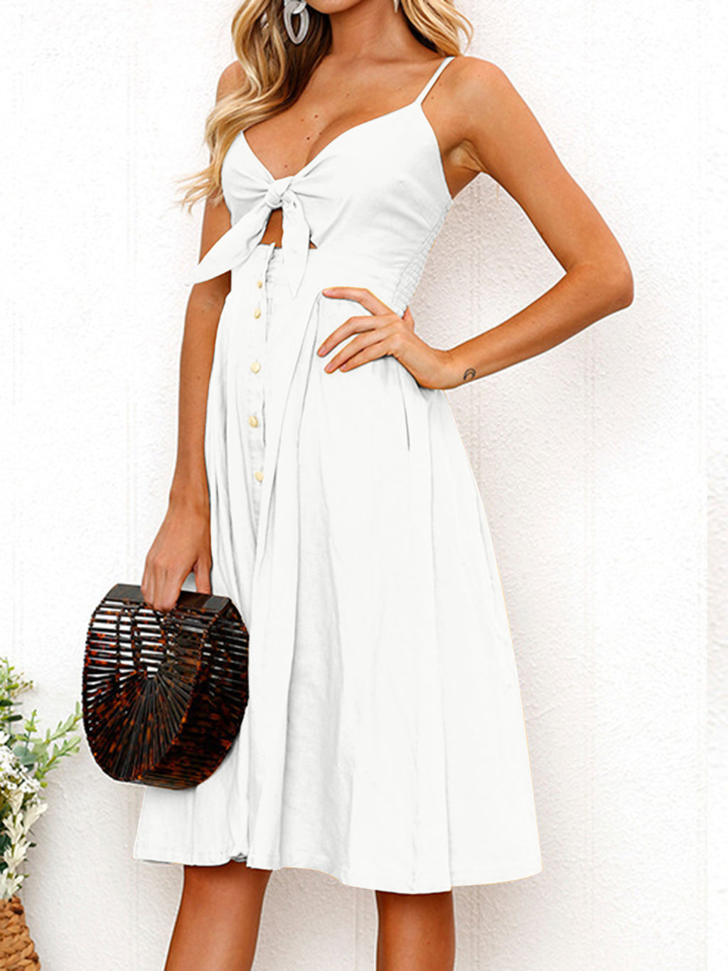 "Chic cutout sweetheart neckline cami dress with decorative button details. Flirty and feminine style, perfect for casual or evening outings."