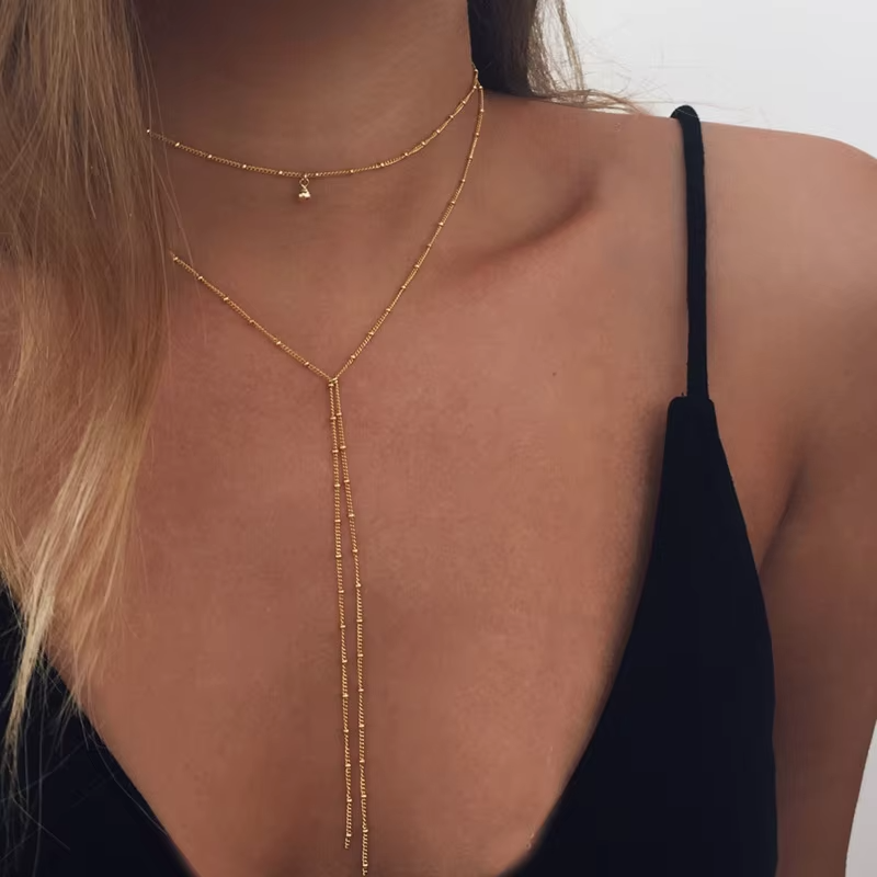"Simple Retro Clavicle Necklace with layered chains and tassel drop, gold-plated alloy, trendy Y-style design."