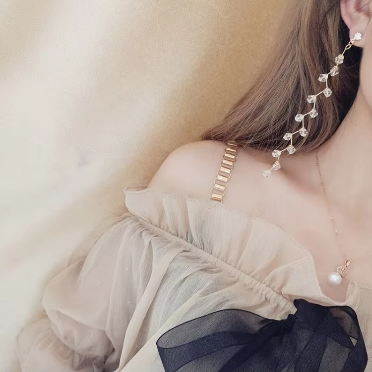 "Elegant long crystal tassel earrings with gold-tone wire and faceted beads – stylish statement jewelry"